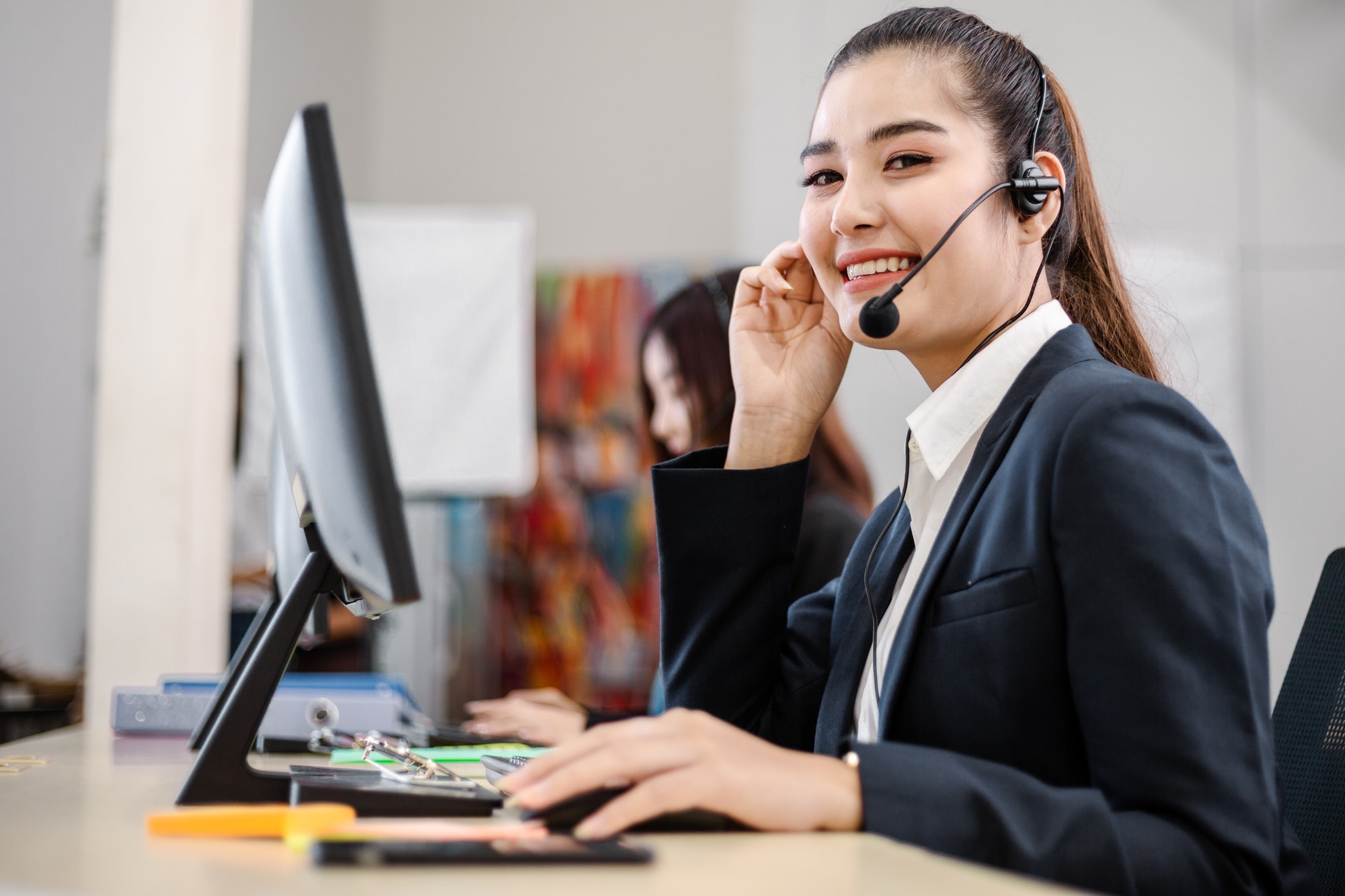asian-call-operator-working-at-desk.jpg